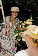 Tasha and Riki making a hanging garland between the ancient yew hedges