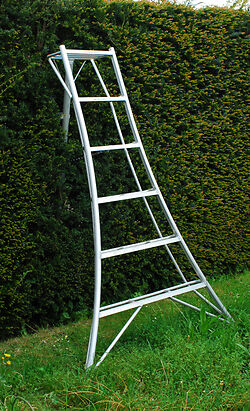 The 6' Original Tripod Ladder with the back leg pushed into the hedge.